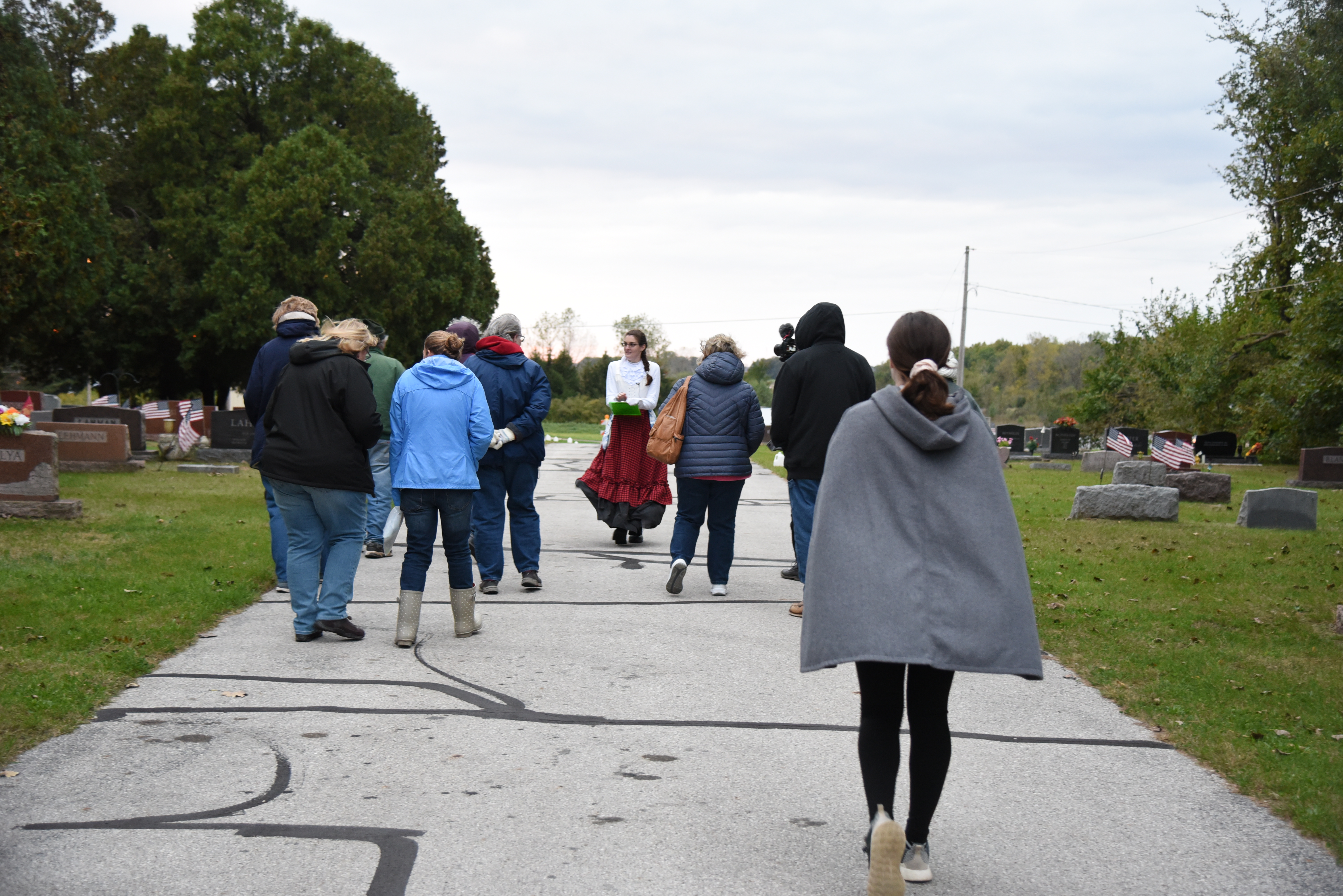 Photo of a group being lead through a cemetery 